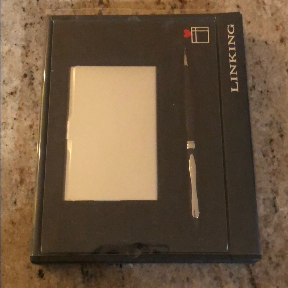 Silver business card holder with black pen